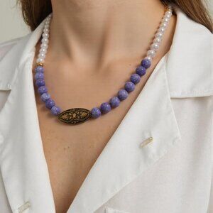 Purple and Pearls beaded necklace with gold and black filagree insert. Adjustabl